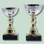 To guldpokaler med sølvskål på marmorbase.