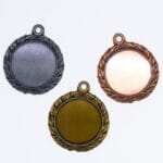 Tre medaljer: guld, sølv, bronze, hvid baggrund.